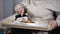 Medical worker serving tasty salad to old female patient, nursing home care