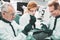 Medical worker wearing glasses holding test tube