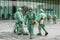 Medical workers in bio viral hazard protective suits disinfects street from coronavirus COVID-19. Antibacterial sanitary