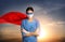 Medical workers fighting with dangerous diseases. Doctor dressed as superhero posing against sky