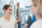 Medical workers talking while patient waits for xray