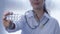 Medicament in hand of doctor woman on white unfocused background