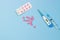 Medications. Electronic thermometer, pink pills and syringe on a blue background