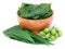 Medicinal neem fruits with leaves in a bowl