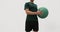 Medicine ball exercises - standing rotation side to side aka standing russian twist. Fit male athlete showing strength