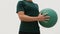 Medicine ball exercises - standing rotation side to side aka standing russian twist. Fit male athlete showing strength