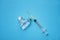 Medicine bottles glass and syringe injection needle on blue background - Medication drug bottle equipment medical tool for nurse