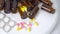 Medicine bottles and multi-colored tablets on white background. Making tablets, pills and other medications