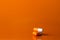 Medicine concept. Three orange capsules lie on an orange background