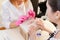 Medicine, cosmetology and manicure. Women in the salon choose the color of nail Polish on the manicure palette of varnishes. Top