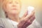 Medicine, hands and woman with bottle of pills for recovery, health and wellness. Closeup, elderly patient and reading