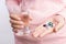 Medicine, health care and people concept - close up of woman taking in pill and another hand holding a glass of clean mineral