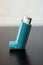 Medicine and health concept: Blue inhaler