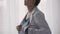 Medicine and health, pediatrics, covid-19 concept - close-up young woman put on white medical gown button up and