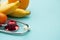 Medicine and healthcare, nutrition or medical insurance over blue background. Fruits and red sthetoscop. Copy space.