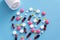 medicine pills on blue background Copy space for text Assorted