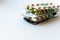 Medicine and pills. Multi-colored medicines on a white background close-up. A pack of plates with multi-colored tablets