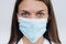 Medicine, profession and healthcare concept - close up of female doctor or scientist in protective facial mask over background