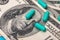 Medicines capsules on dollar bills