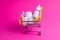 Medicines, drops in a metal trolley for a buyer from a supermarket on a pink paper background. The concept of medicine and the