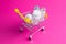 Medicines, drops in a metal trolley for a buyer from a supermarket on a pink paper background. The concept of medicine and the