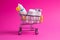 Medicines, drops in a metal trolley for a buyer from a supermarket on a pink paper background. The concept of medicine and the