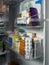 Medicines in packages, tablets in blisters, syringes for injections are placed on the shelves of the refrigerator door.