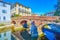 Medieval arched Ponte di San Gerardino bridge above Lambro river in Monza town, Italy