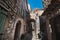 Medieval architecture: a cobbled street with a stone arch and dry grass shows of how a medieval village must have looked like