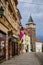 Medieval black gothic water tower at the end of narrow picturesque street with colorful historical buildings in center of Plzen in