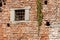 Medieval brick wall - Window with wrought iron bars