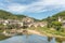 Medieval bridge over Lot with castle in village of Estaing