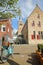 Medieval buildings and the clock tower of Martinikerk St Martin church viewed from Raadhuisplein street in Franeker