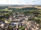 Medieval castle with fortified walls, towers and donjon in rural village in France, aerial view from drone of renovated fortress