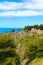 Medieval castle ruins Rocca di Cefalu captured on vertical photo with blue Tyrrhenian sea in background. The historical site