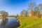 Medieval castle Slot Loevestein by earthen wall and moat at River Waal