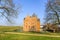 Medieval castle Slot Loevestein by earthen wall and moat at River Waal