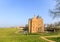 Medieval castle Slot Loevestein by earthen wall and moat at River Waal