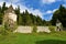 Medieval castle wall with a tower on each side and forest behind at Zicka kartuzija