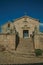 Medieval chapel facade in front of stone staircase