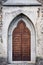 Medieval church door close up. Gothic cathedral door fragment with stone steps. Beautiful wooden entrance with decorations