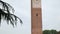 Medieval clock tower seen from university courtyard in Pavia, PV, Italy