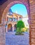 The medieval court of Casa de las Bulas through the arch, Cordoba, Spain
