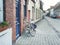 Medieval empty side street of Bruges, Belgium, with a bike parked at one side