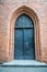 Medieval entrance door in a red brick wall