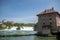 Medieval europe style Buildings on big river with beautiful waterfall and blue sky background