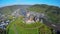 Medieval European castle aerial shot village vine hills clouds