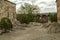 Medieval fortress of Khor Virap and a courtyard with living quarters, khachkars against the wall and trees growing among the stone