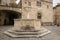 Medieval fountain and San Silvestro Church facade in the main square of the town of Bevagna in Umbria Italy.