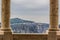 Medieval gazebo stone column symmetry architecture frame on unfocused mountain and cloudy sky background